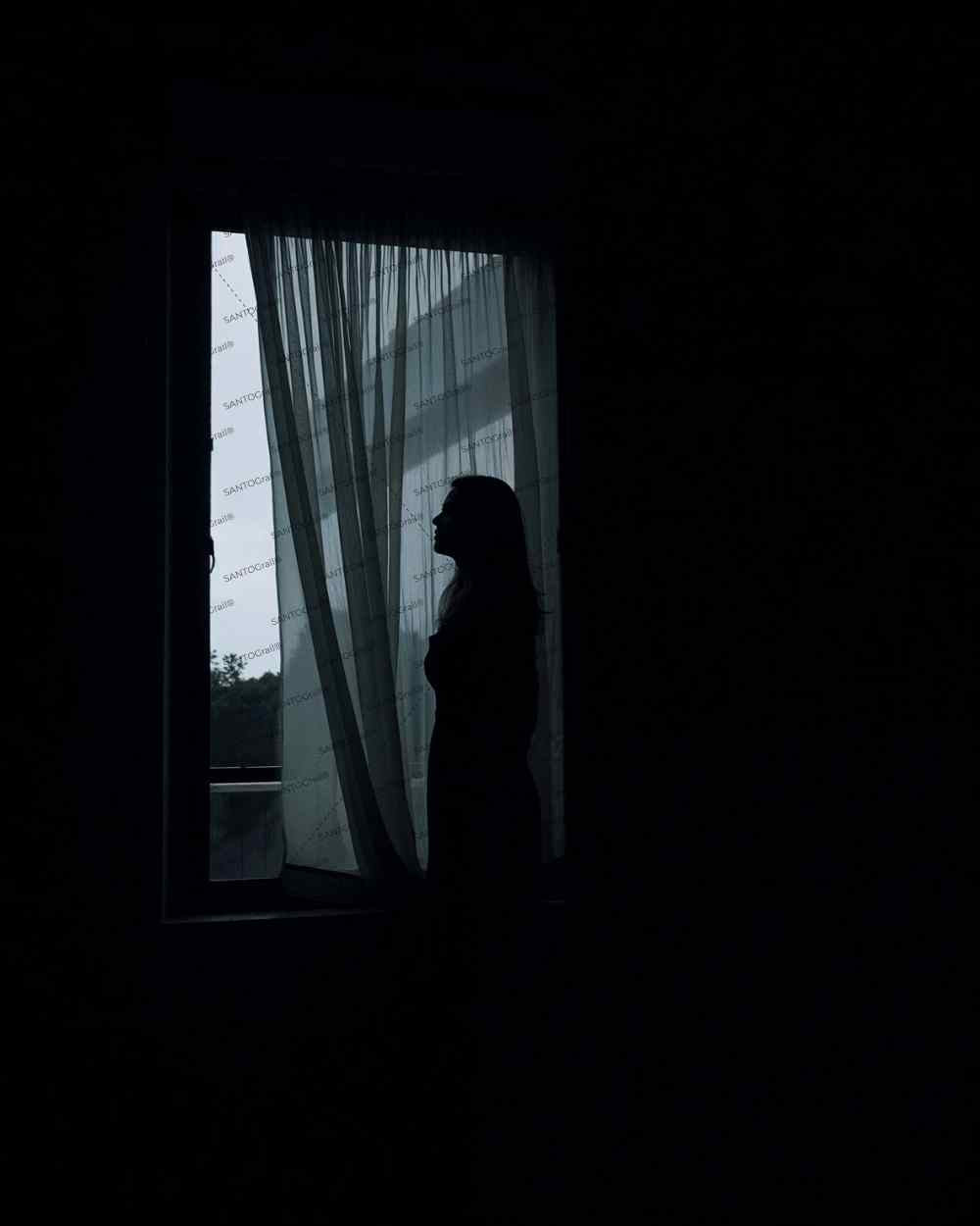 Anonymous woman obscured by blowing curtain for cover book. Noir art ilustration.