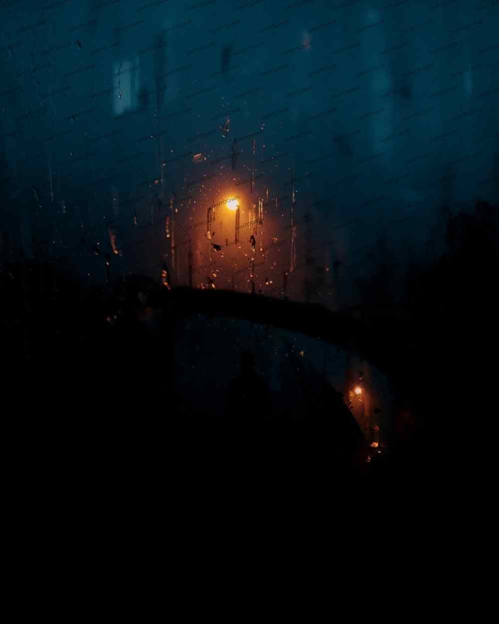 Blurry-anonymous-figure-in rainy carrear view mirror for cover book.